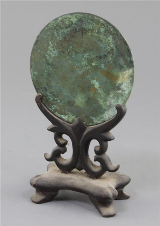 A Chinese bronze circular TLV mirror, Han dynasty or later, 11cm diameter
